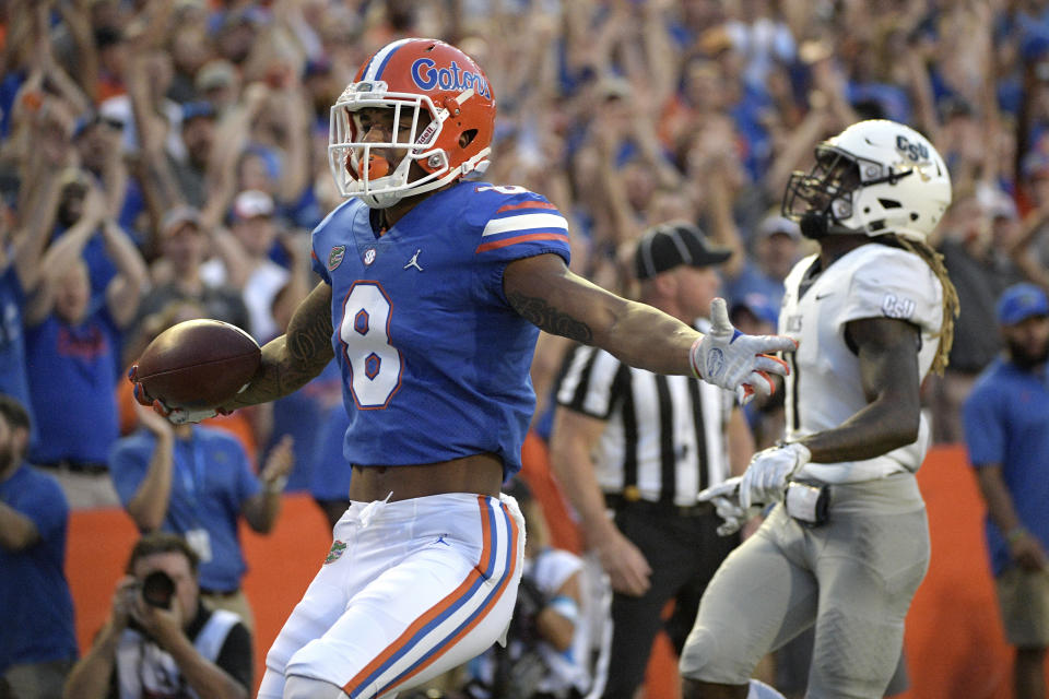 Florida wide receiver Trevon Grimes (8) celebrates after running into the end zone for a 34-yard receiving touchdown in front of Charleston Southern defensive back Brandon Rowland (7) during the first half of an NCAA college football game, Saturday, Sept. 1, 2018, in Gainesville, Fla. (AP Photo/Phelan M. Ebenhack)
