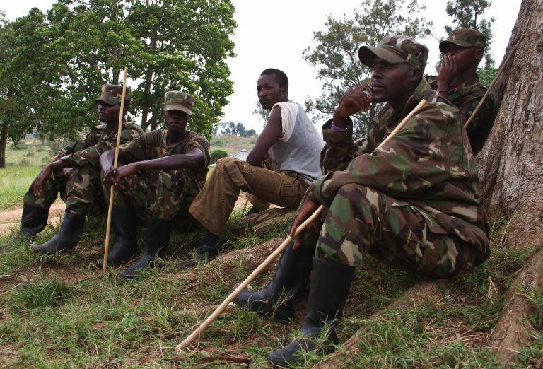 Members of the former Congolese M23 rebels sit at a compound in Bihanga's Training School, south west of the capital Kampala on February 7, 2014