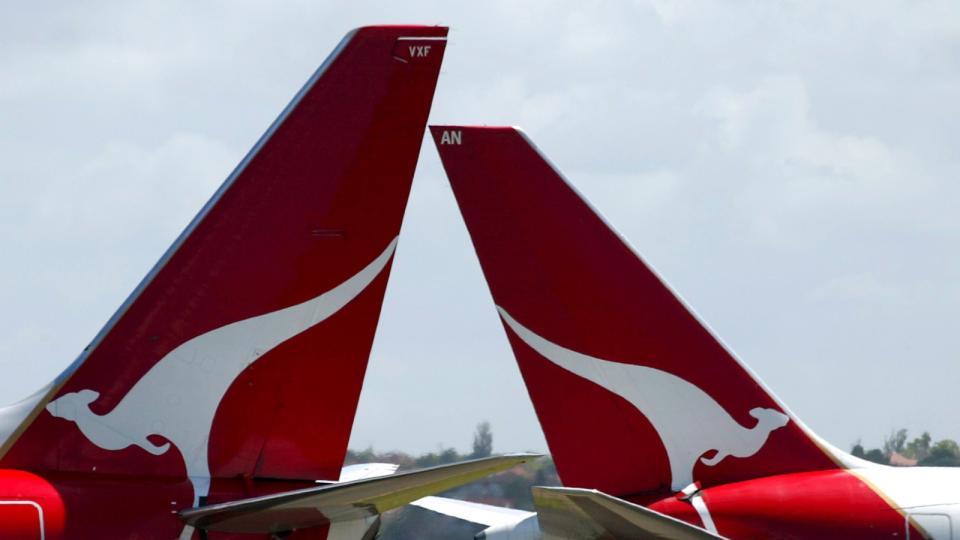 Two Qantas plane tails featuring the flying kangaroo logo