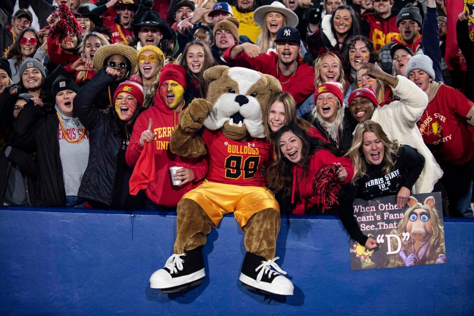 The Ferris State bulldog celebrates a touchdown with fans in the first half of the Division II championship NCAA college football game against Valdosta State in McKinney, Texas, Saturday, Dec. 18, 2021. (AP Photo/Emil Lippe)