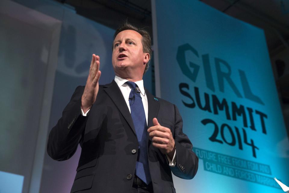 Britain's Prime Minister David Cameron speaks at the 'Girl Summit 2014' at the Walworth Academy in London July 22, 2014. Britain is to make it compulsory for teachers and health workers to report cases of female genital mutilation (FGM), Prime Minister David Cameron said on Tuesday. The government, which is hosting a London summit on FGM and forced marriage, will also announce a range of other measures aimed at bringing an end to both practices in Britain and abroad, Cameron's office said in a statement. REUTERS/Oli Scarff/Pool (BRITAIN - Tags: POLITICS SOCIETY)