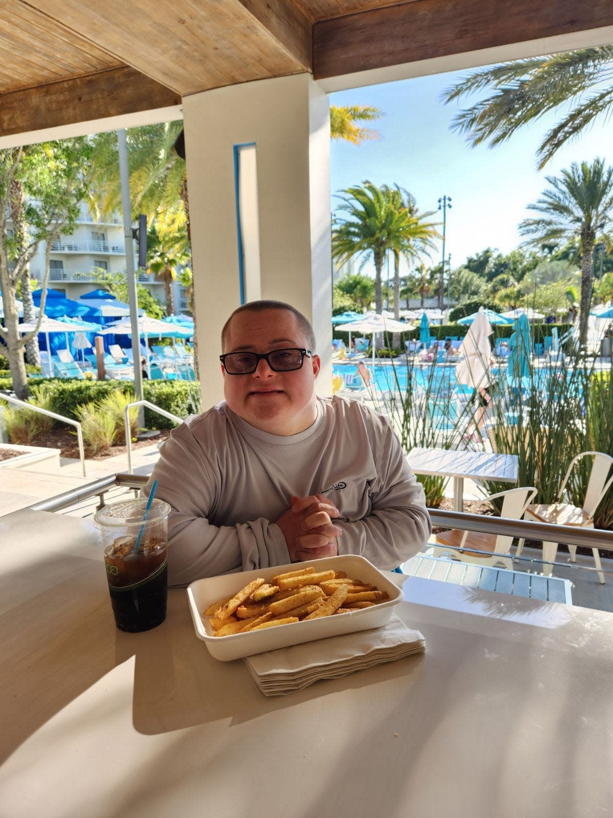 Matthew Speheger enjoys French fries and a Dr. Pepper. He will be greeting friends at the Michiana Down Syndrome golf outing on June 1, 2024, at Juday Creek Golf Course in Granger.