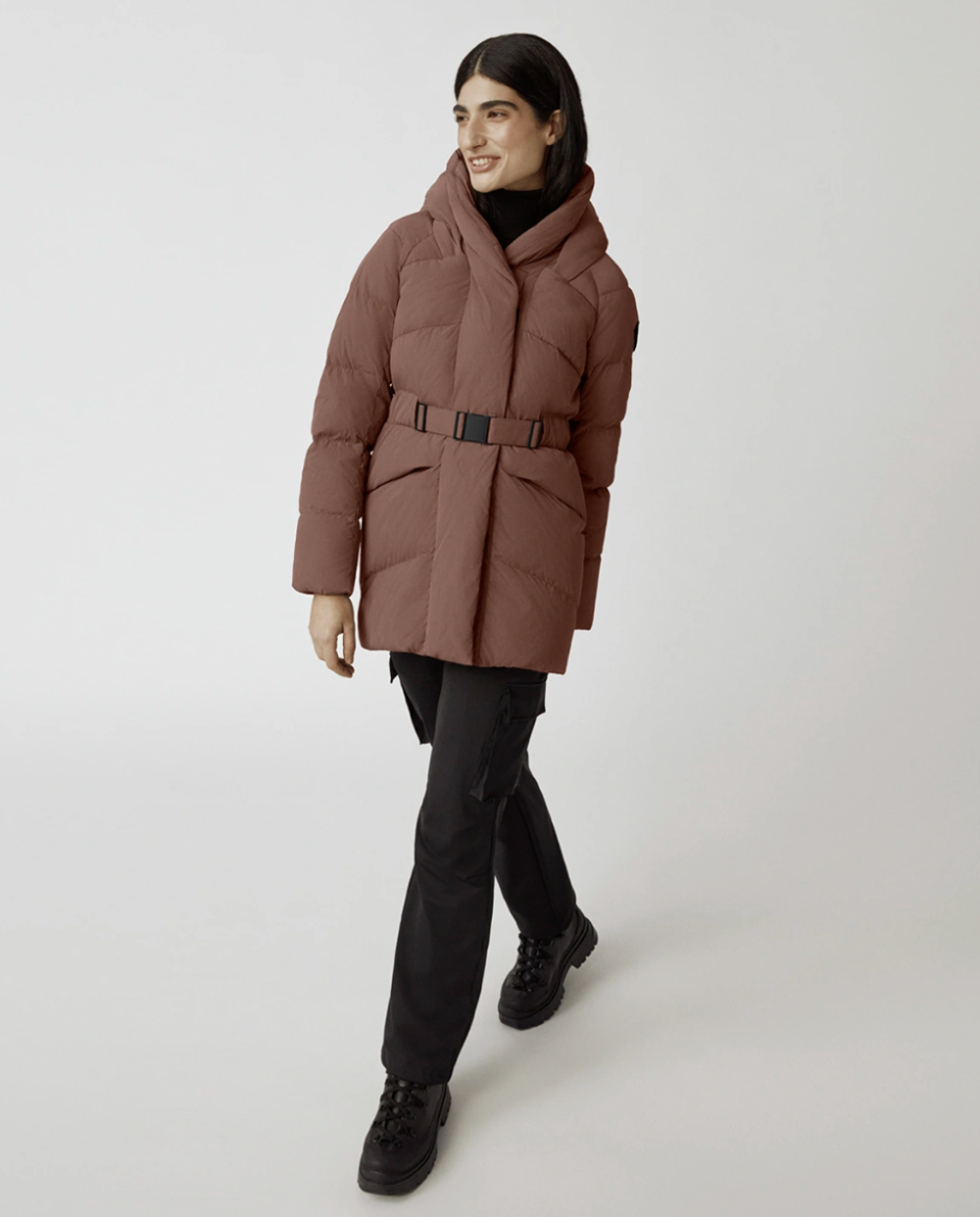 model wearing black boots, black pants and dark rose Marlow Coat in Sephia (Photo via Canada Goose)