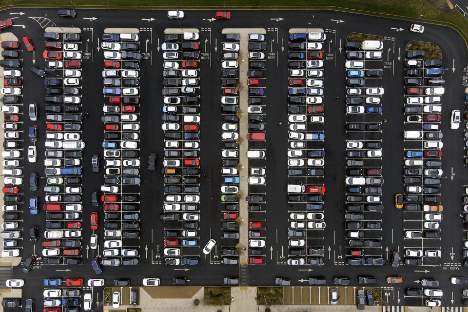 Christmas shoppers fill the car park at Fosse Shopping Park in Leicester, England, Thursday, Dec. 23, 2021. The British government says it won’t introduce any new coronavirus restrictions until after Christmas, and called early studies on the severity of the omicron variant encouraging. ( Joe Giddens/PA via AP)