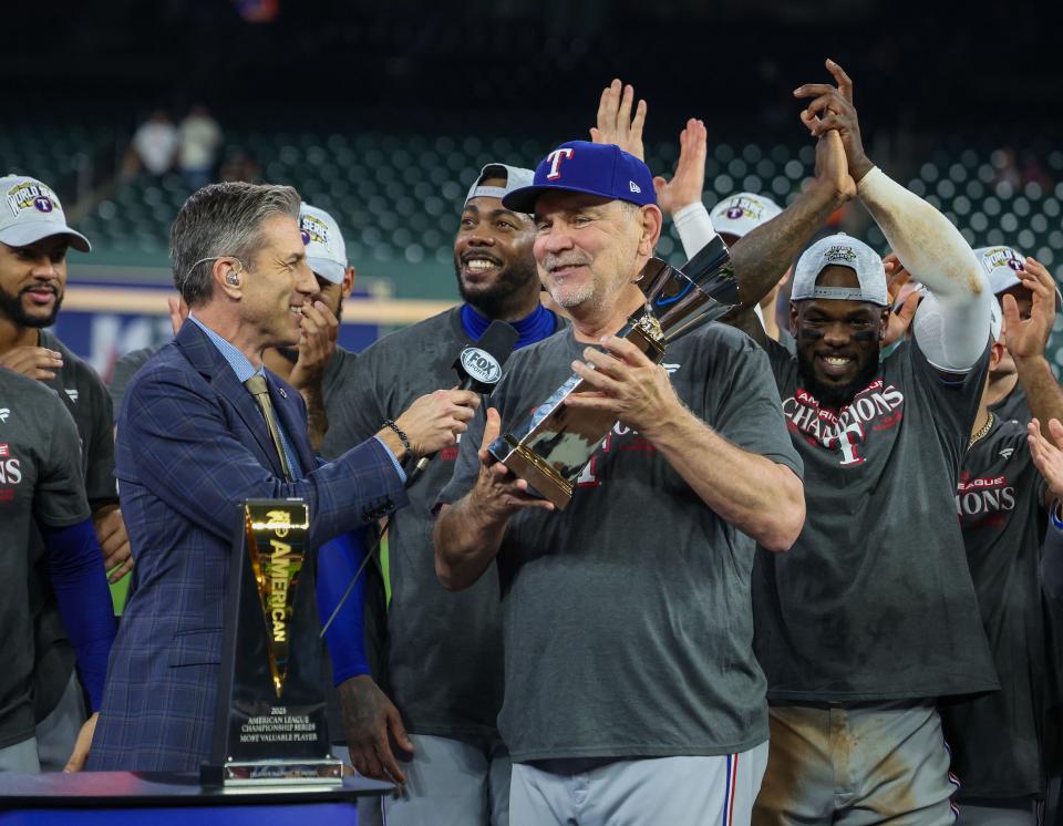 The Texas Rangers manager Bruce Bochy and teammates celebrate defeating the Houston Astros on Oct. 23, 2023, after Game 7 of the ALCS in the MLB playoffs at Minute Maid Park in Houston, Texas.