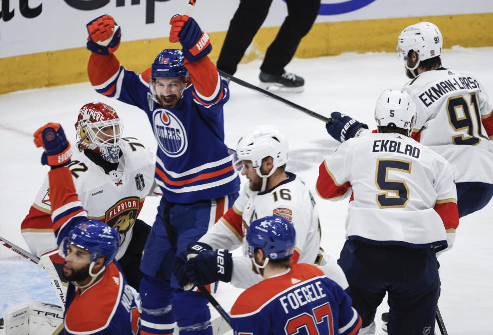 Florida Panthers goalie Sergei Bobrovsky (72) looks on as Edmonton Oilers' Zach Hyman (18) celebrates a goal during the second period of Game 4 of the NHL hockey Stanley Cup Final, Saturday, June 15, 2024, in Edmonton, Alberta. (Jeff McIntosh/The Canadian Press via AP)