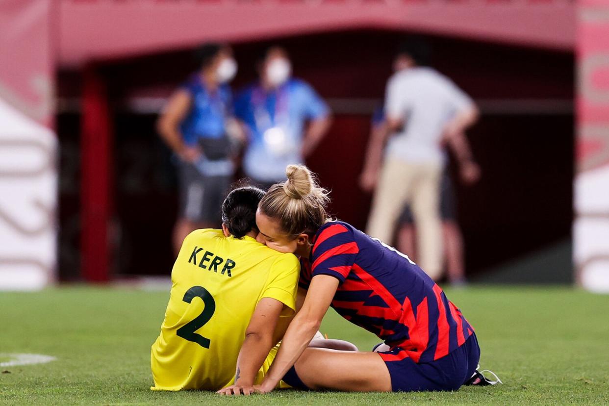 Kristie Mewis #6 of United States embraces Sam Kerr #2 of Australia