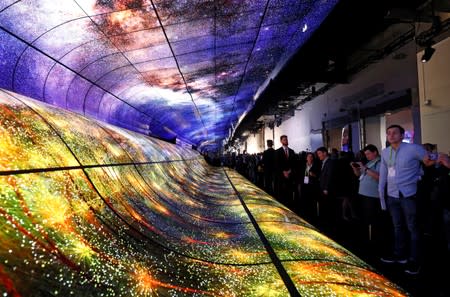 FILE PHOTO: Attendees watch a display made up of curved OLED television screens at the LG Electronics booth during the 2019 CES in Las Vegas