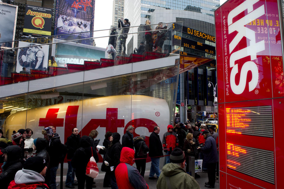 FILE - People wait in line at the Times Square TKTS discount ticket booth in New York on Jan. 19, 2012. The TKTS booth in Times Square, which has become part of the city's visual and financial DNA and a key part in keeping Broadway going, celebrates its 50th birthday this week. (AP Photo/Charles Sykes, File)