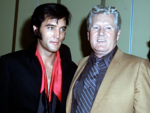 <p>Michael Ochs Archives/Getty</p> Elvis Presley and his father Vernon Presley during a press conference after his first performance at the International Hotel in 1969