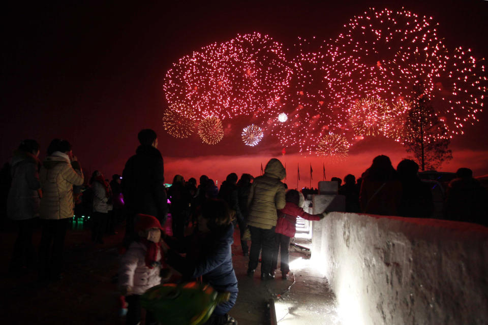 <p>North Koreans watch as fireworks explode as part of New Year celebrations, above the Taedong River as viewed from Kim Il Sung Square, in Pyongyang, North Korea. (Photo: Jon Chol Jin/AP) </p>