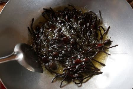 Tarantulas are fried in a pan in Kampong Cham province in Cambodia, April 19, 2017. REUTERS/Samrang Pring