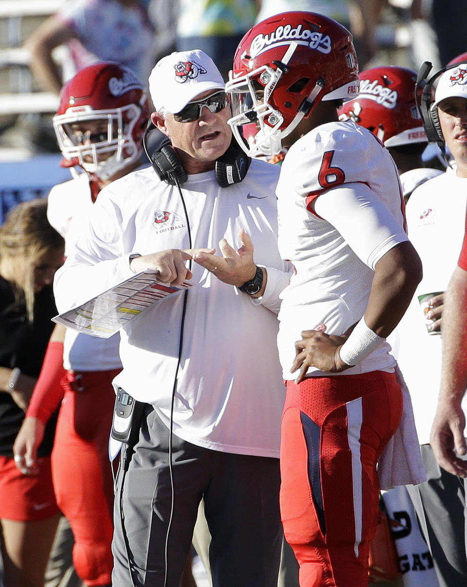 FSU head coach Jeff Tedford, left, talks with quarterback Marcus McMaryion during the first half of a win over SJSU. (AP)