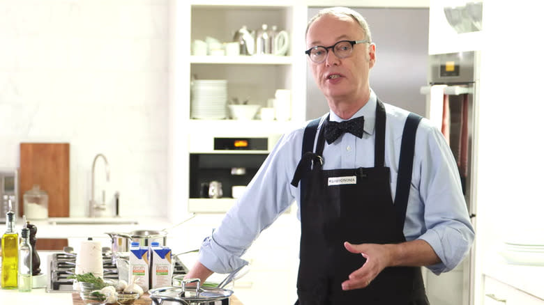 Christopher Kimball explaining in the kitchen