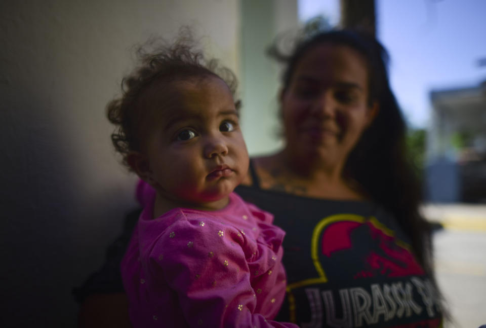 One-year-old Lius Paulette sits with her mother Alexandra Colberg, as they prepare to move to the town of Hormigueros where Colberg said they have family, after an earthquake damaged their home in Guanica, Puerto Rico, Tuesday, Jan. 7, 2020. A 6.4-magnitude earthquake struck Puerto Rico before dawn on Tuesday, killing one man, injuring others and collapsing buildings in the southern part of the island. (AP Photo/Carlos Giusti)