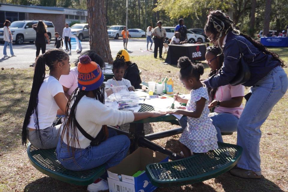 Attendees gather around a table to do arts and crafts at the Gainesville Housing Authority's “Revitalizing Our Roots" Black History Month event on Saturday in east Gainesville.
(Credit: Photo by Voleer Thomas, Correspondent)