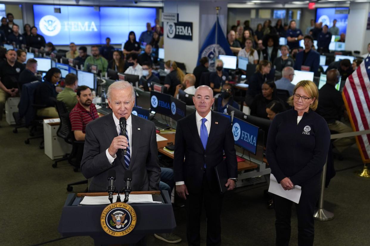 President Joe Biden speaks about Hurricane Ian during a visit to FEMA headquarters, Thursday, Sept. 29, 2022, in Washington. FEMA Administrator Deanne Criswell, right, and Homeland Security Secretary Alejandro Mayorkas look on.