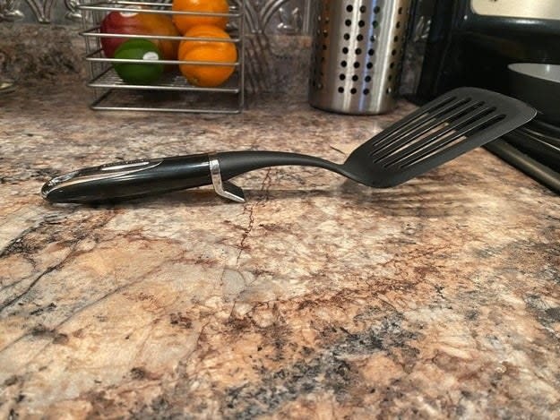 A spatula with a little metal kickstand