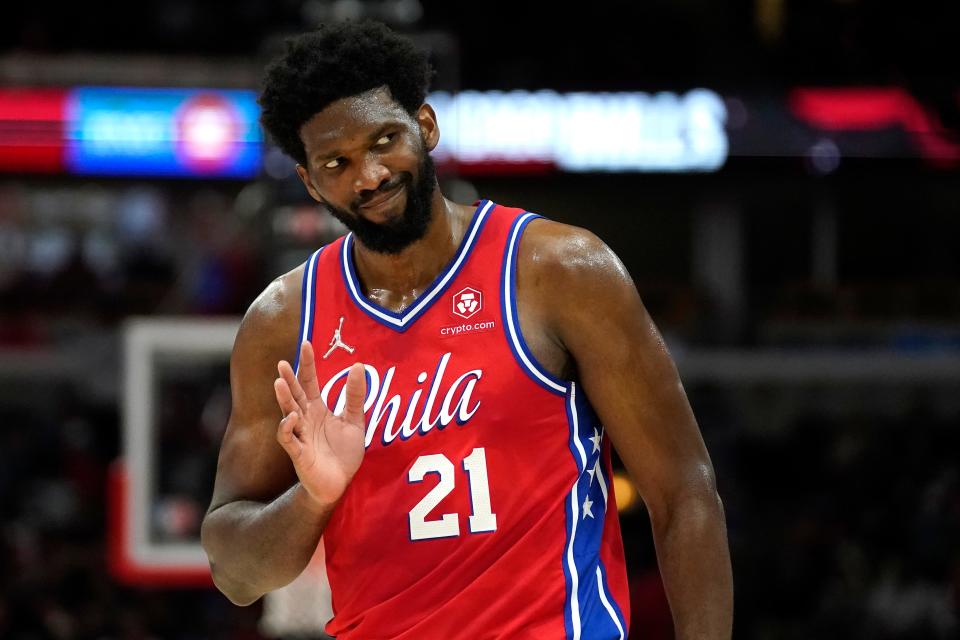 Philadelphia 76ers' Joel Embiid waves to Chicago Bulls fans after hitting a 3-point shot late in the second half of the team's NBA basketball game against the Bulls of Saturday, Nov. 6, 2021, in Chicago. The 76ers won 114-105.