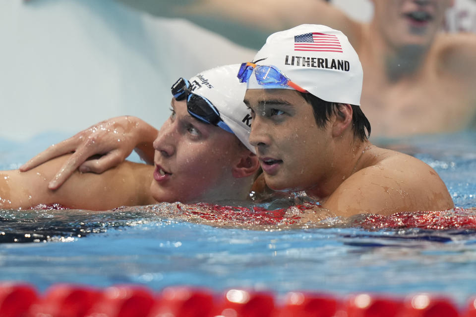 Jay Litherland, of the United States, embraces teammate Chase Kalisz, right, after the final of the men's 400-meter individual medley at the 2020 Summer Olympics, Sunday, July 25, 2021, in Tokyo, Japan. (AP Photo/Matthias Schrader)