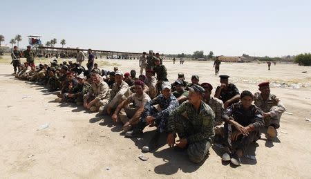 Shi'ite volunteers, who have joined the Iraqi army to fight against militants of the Islamic State, formerly known as the Islamic State in Iraq and the Levant (ISIL), gather together during training in Baghdad July 9, 2014. REUTERS/Ahmed Saad