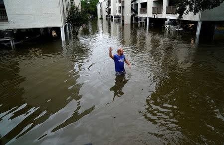 FILE PHOTO: A volunteer looks for people wanting to be evacuated from the Hurricane Harvey floodwaters in Dickinson, Texas, U.S., August 28, 2017. REUTERS/Rick Wilking/File Photo