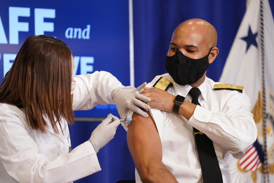 U.S. Surgeon General Jerome Adams receives a Pfizer-BioNTech COVID-19 vaccine shot at the Eisenhower Executive Office Building on the White House complex, Friday, Dec. 18, 2020, in Washington. Vice President Mike Pence, his wife Karen Pence also participated. (AP Photo/Andrew Harnik)