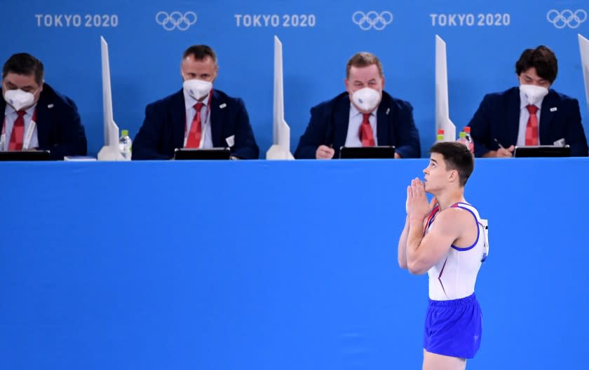 -TOKYO,JAPAN July 26, 2021: ROC's Nikita Nagornyy prays as he walks past the judges before realizing he won the gold medal in the men's team final at the 2020 Tokyo Olympics. (Wally Skalij /Los Angeles Times)