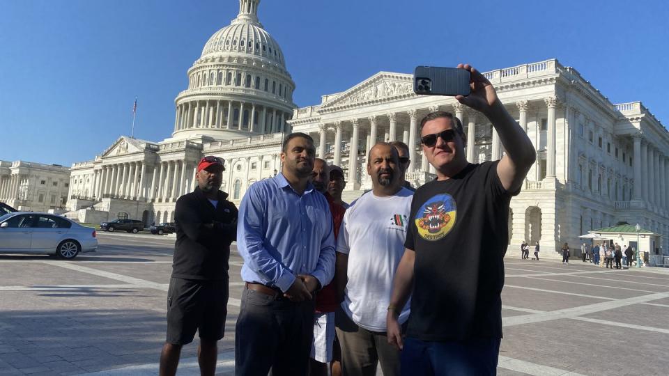 Activist Matt Zeller (right) records a video update of the ongoing veterans protest outside the Capitol building on Sept. 20, 2022. With him are Navy reservist Safi Rauf (left), Afghan refugee Shershah Wahidi (second from left) and other protestors. (Leo Shane III/Staff)