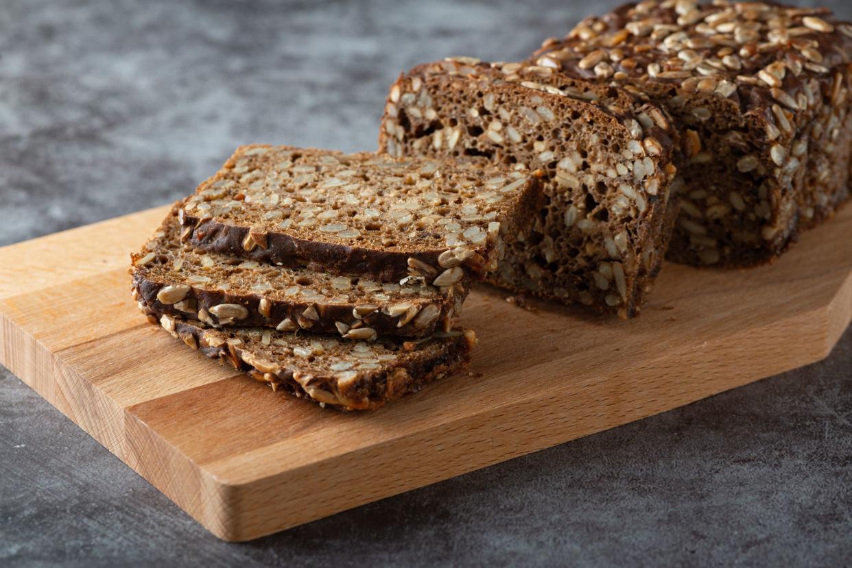 Sliced rye bread on cutting board.