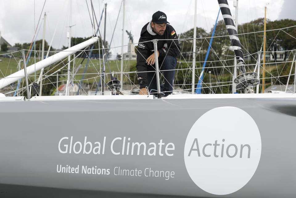 Skipper Boris Herrmann works on the boat Malizia as it is moored in Plymouth, England Tuesday, Aug. 13, 2019. Greta Thunberg, the 16-year-old climate change activist who has inspired student protests around the world, is heading to the United States this week - in a sailboat. (AP Photo/Kirsty Wigglesworth)