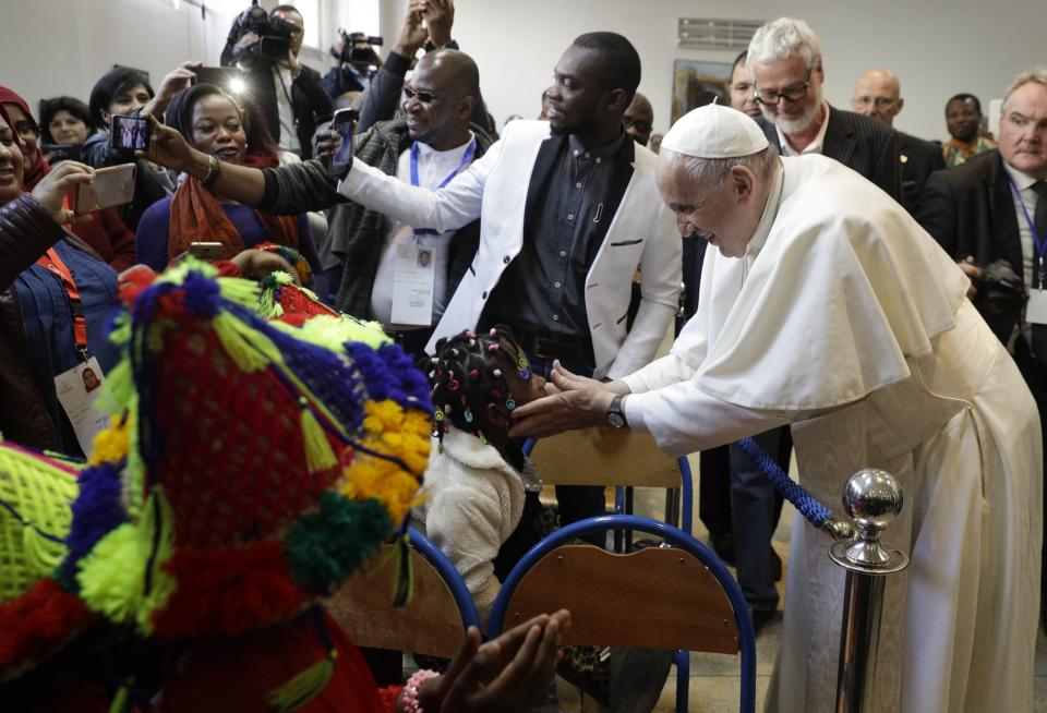 Pope Francis meets migrants at the diocesan Caritas center in Rabat, Morocco, Saturday, March 30, 2019. Francis's weekend trip to Morocco aims to highlight the North African nation's tradition of Christian-Muslim ties while also letting him show solidarity with migrants at Europe's door and tend to a tiny Catholic flock on the peripheries. (AP Photo/Gregorio Borgia)