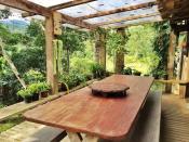 <p>The breakfast table lets you experience the beautiful rainforest morning with a little protection from the elements. (Airbnb) </p>