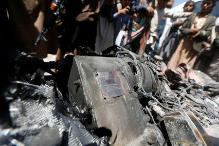 People gather around the engine of a drone aircraft which the Houthi rebels said they have downed in Sanaa, Yemen October 1, 2017. REUTERS/Khaled Abdullah