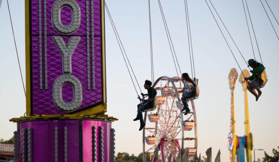 Fairgoers ride the YoYo at the Stanislaus County Fair in Turlock, Calif., Friday, July 7, 2023.