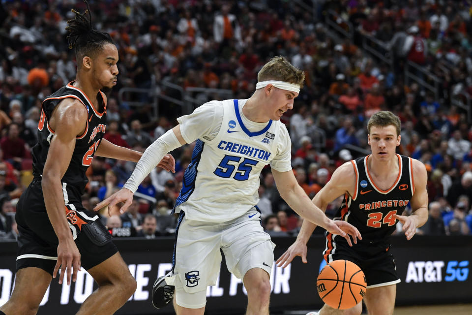 Creighton guard Baylor Scheierman (55) moves the ball against Princeton guard Blake Peters (24) in the first half of a Sweet 16 round college basketball game in the South Regional of the NCAA Tournament, Friday, March 24, 2023, in Louisville, Ky. (AP Photo/Timothy D. Easley)