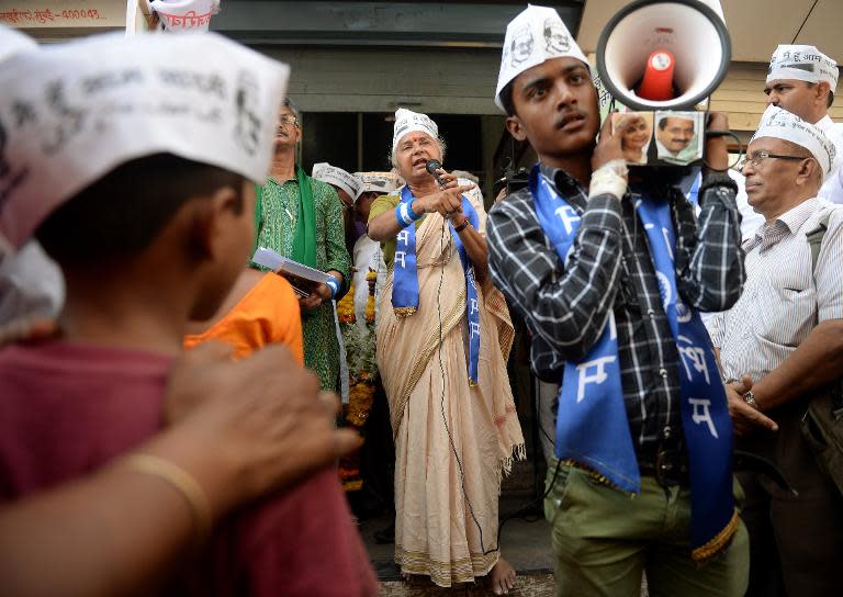 Indian activist and Aam Aadmi Party (AAP) candidate Medha Patkar (C) addresses supporters outside the party office before starting an election roadshow in Mumbai, April 14, 2014