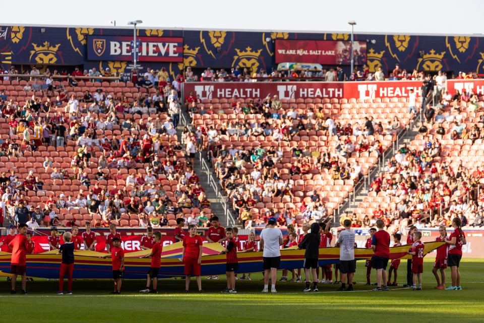 Fans carry the RSL flag onto the field before the Real Salt Lake vs. Orlando City soccer match at the America First Field in Sandy on Saturday, July 8, 2023. | Megan Nielsen, Deseret News