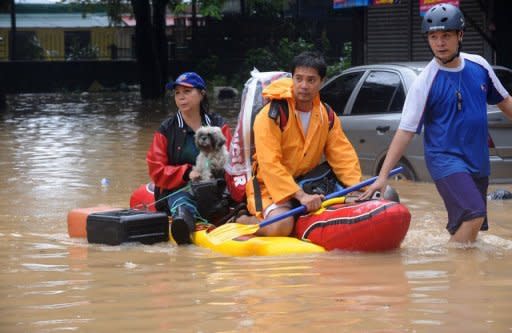 Manila residents are evacuated from a suburb of Manila. Philippine authorities have appealed for help in getting relief to two million people affected by deadly floods in and around the capital, warning that evacuation centres were overwhelmed