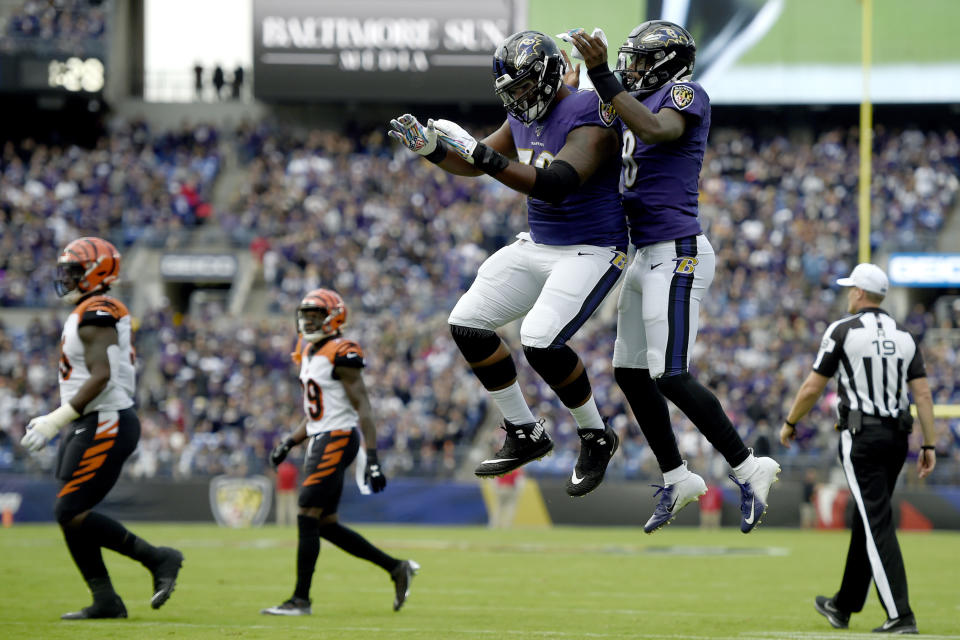 Baltimore Ravens offensive tackle Ronnie Stanley, left, and quarterback Lamar Jackson celebrate Jackson's touchdown run against the Cincinnati Bengals during the first half of a NFL football game Sunday, Oct. 13, 2019, in Baltimore. (AP Photo/Gail Burton)