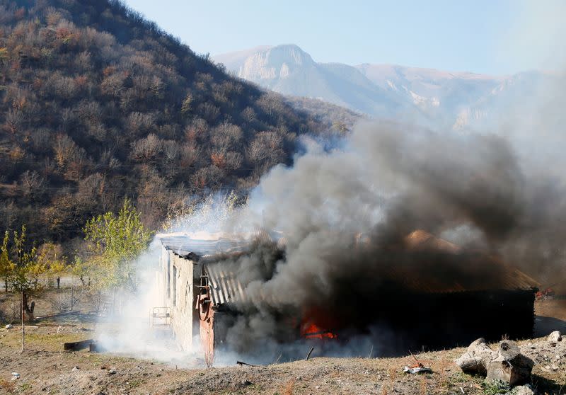 A house is seen set on fire by departing Ethnic Armenians in the village of Cherektar, in the region of Nagorno-Karabakh