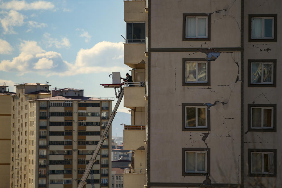 A survivor retrieves belongings from his damaged appartment in Kahramanmaras, Turkey, Wednesday, Feb. 15, 2023. More than 35,000 people have died in Turkey as a result of last week's earthquake, making it the deadliest such disaster since the country's founding 100 years ago. While the death toll is almost certain to rise even further, many of the tens of thousands of survivors left homeless were still struggling to meet basic needs, like finding shelter from the bitter cold. (AP Photo/Emrah Gurel)