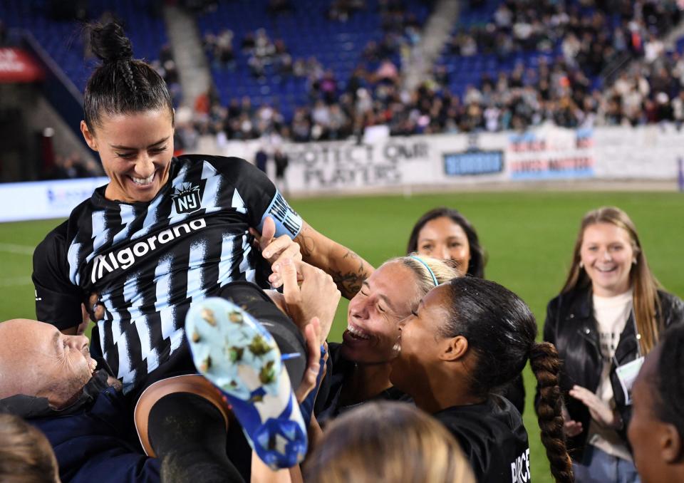 Ali Krieger hoisted into the air by her Gotham teammates.