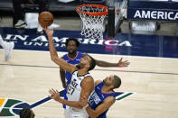 Utah Jazz center Rudy Gobert (27) scores against Los Angeles Clippers Nicolas Batum (33) during the second half of an NBA basketball game Friday, Jan. 1, 2021, in Salt Lake City. (AP Photo/Rick Bowmer)