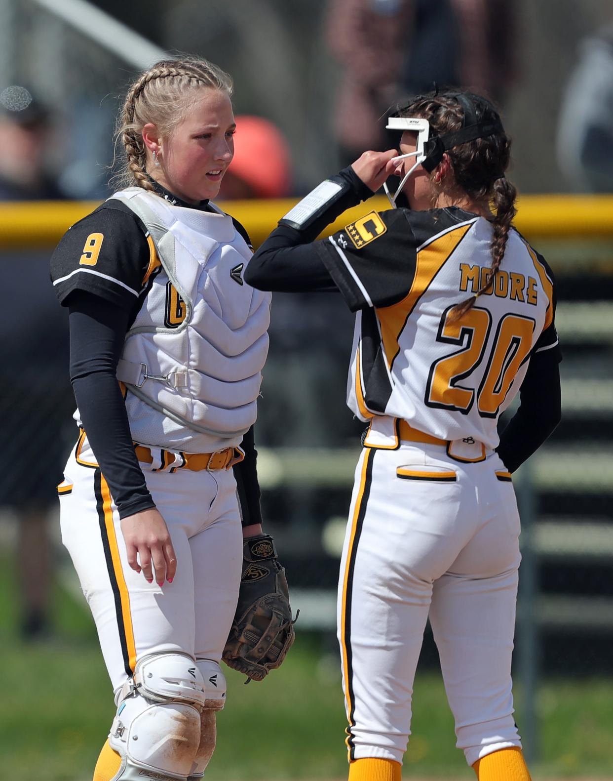 Garfield catcher Kolby Fresch, left, has a word with pitcher Lizzy Moore during the second inning of a high school softball game against Crestwood, Saturday, April 20, 2024, in Garrettsville, Ohio.