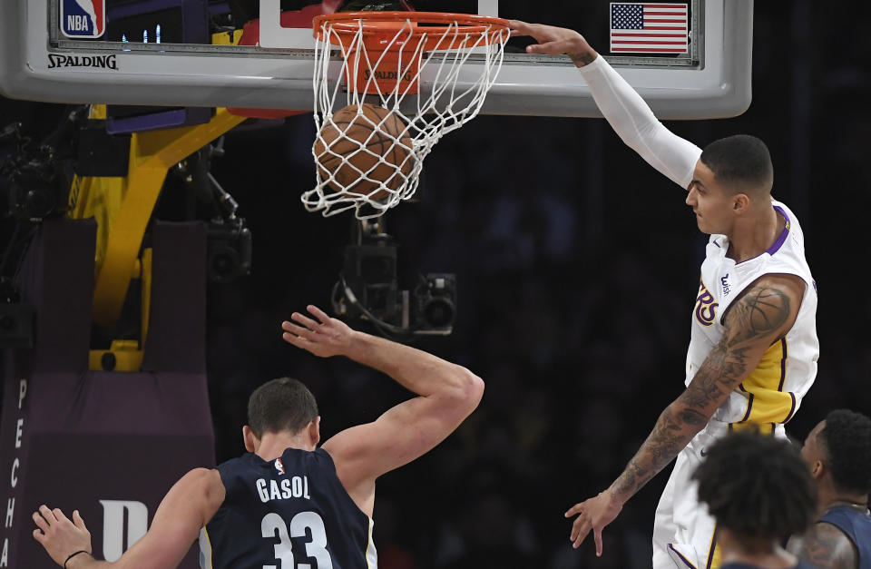 Kyle Kuzma, right, dunks on Grizzlies center Marc Gasol during Sunday’s Lakers win. (AP)