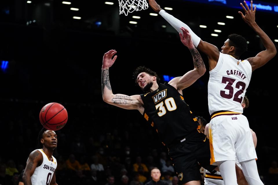 Virginia Commonwealth's Brandon Johns Jr. (30) loses control of the ball as he drives past Arizona State's Alonzo Gaffney (32) during the second half of an NCAA college basketball game at the Legends Classic Wednesday, Nov. 16, 2022, in New York. Arizona State won 63-59. (AP Photo/Frank Franklin II)