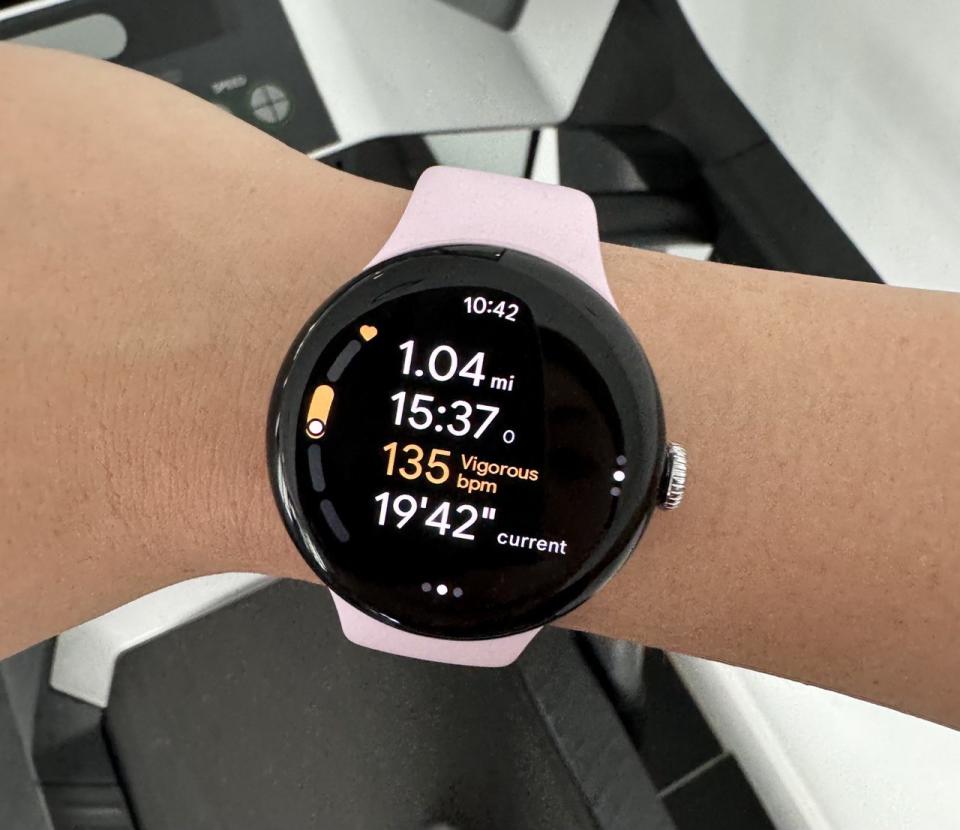 The Pixel Watch 3 on a wrist, with a treadmill in the background. The screen shows a run being logged, with 1.04 miles already having been recorded. 