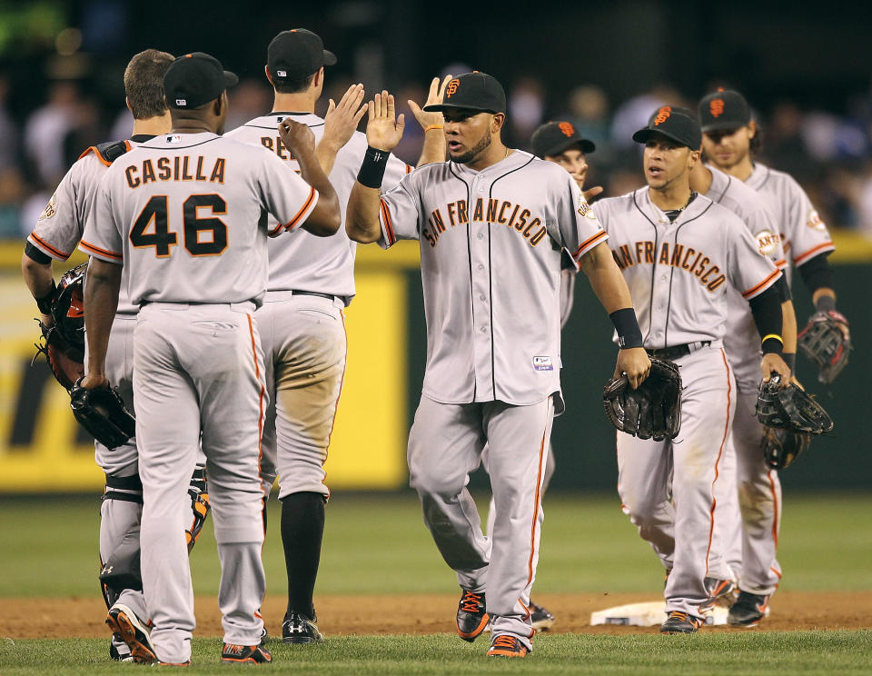 SEATTLE, WA - JUNE 15: Members of the San Francisco Giants celebrate after defeating the Seattle Mariners 4-2 at Safeco Field on June 15, 2012 in Seattle, Washington. (Photo by Otto Greule Jr/Getty Images)