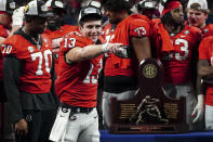 Georgia quarterback Stetson Bennett (13) gestures to the crowd during the trophy presentation the Southeastern Conference Championship football game Saturday, Dec. 3, 2022 in Atlanta. (AP Photo/John Bazemore)